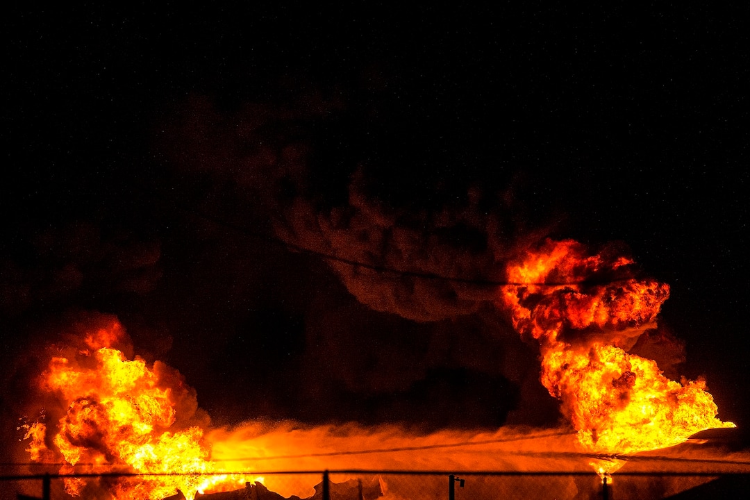 (Chris Detrick  |  The Salt Lake Tribune)  Firefighters attempt to put out a burning semitrailer that was hauling thousands of gallons of fuel on Interstate-15 in Midvale Thursday, January 18, 2018.   Lt. Todd Royce of the Utah Highway Patrol said the truck was southbound on the interstate at 7500 South at 7:20 p.m. when a tire caught fire, sending flames toward the tanks.