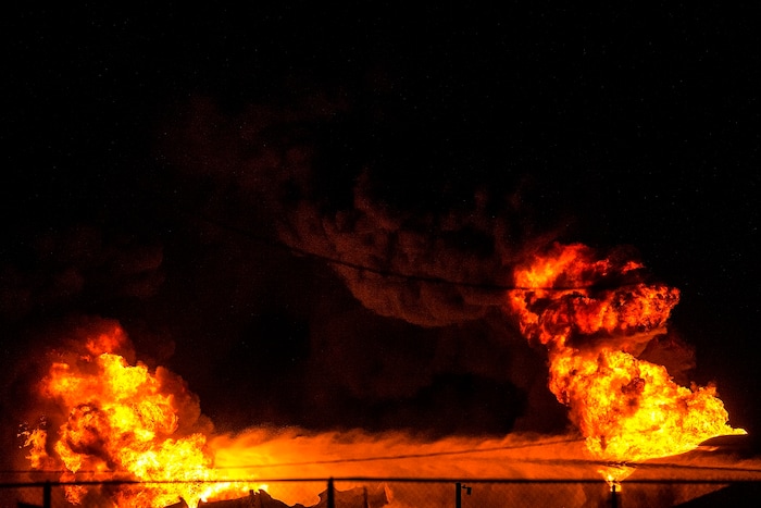 (Chris Detrick  |  The Salt Lake Tribune)  Firefighters attempt to put out a burning semitrailer that was hauling thousands of gallons of fuel on Interstate-15 in Midvale Thursday, January 18, 2018.   Lt. Todd Royce of the Utah Highway Patrol said the truck was southbound on the interstate at 7500 South at 7:20 p.m. when a tire caught fire, sending flames toward the tanks.