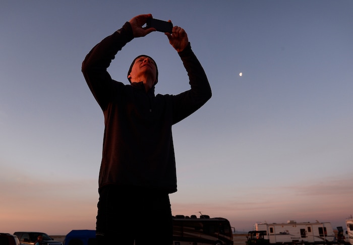 (Scott Sommerdorf | The Salt Lake Tribune)
Peter Van Horn makes a photo of the Salt Flats as the sun rises at the Salt Flats 100 Endurance Run, Saturday, May 5, 2018. Van Horn paced his brother Matt Van Horn who won the race.

