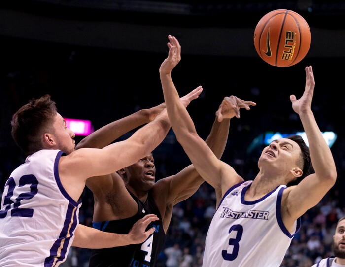 (Francisco Kjolseth | The Salt Lake Tribune) Westminster Griffins guard Taylor Miller (3) battles for a ball against Brigham Young Cougars forward Fousseyni Traore (45) in basketball action between the Brigham Young Cougars and the Westminster Griffins at the Marriott Center in Provo, Wednesday, Dec. 29, 2021.