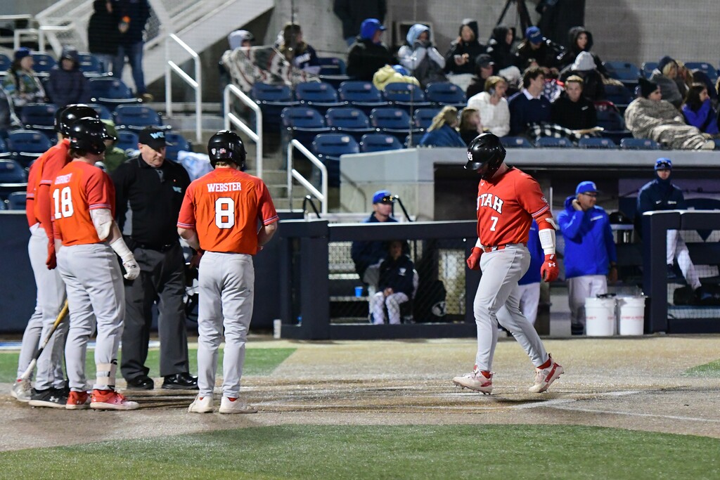 (Utah Athletics) Utah's Jayden Kiernan (7) touches home plate after hitting his first career grand slam during the Utes' 29-14 win at BYU's Miller Park on April 18, 2023. Bruer Webster (8) and Cameron Gurney (18) are among the welcoming committee. Brad Lapp/Utah athletics
