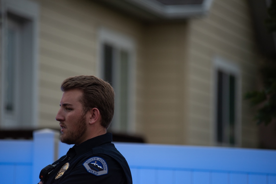 (Niki Chan Wylie |Special to The Tribune) Officer Jeff Petersen guards the gated entrance as a police team works on detonating explosive material found inside a home in South Jordan on Friday, July 24.
