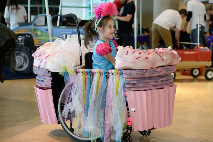 (Francisco Kjolseth  |  The Salt Lake Tribune)  Phyllis Choate gets to celebrate her fifth birthday as Princess Poppy in a cupcake as volunteers and staff at Shriners Hospital for Children in Salt Lake transform the wheelchairs of 28 patients for Halloween, Wednesday, Oct. 17, 2018. Phyllis, who was born with a brain bleed and has white matter loss in her brain that kept her from speaking, saw improvement with her speech when she saw the "Trolls" movie. "The movie was a big turning point for her," exclaimed her mother, Shannon, "her whole world is 'Trolls,' and the song 'True Colors' was one of the first things she said at age 4."
