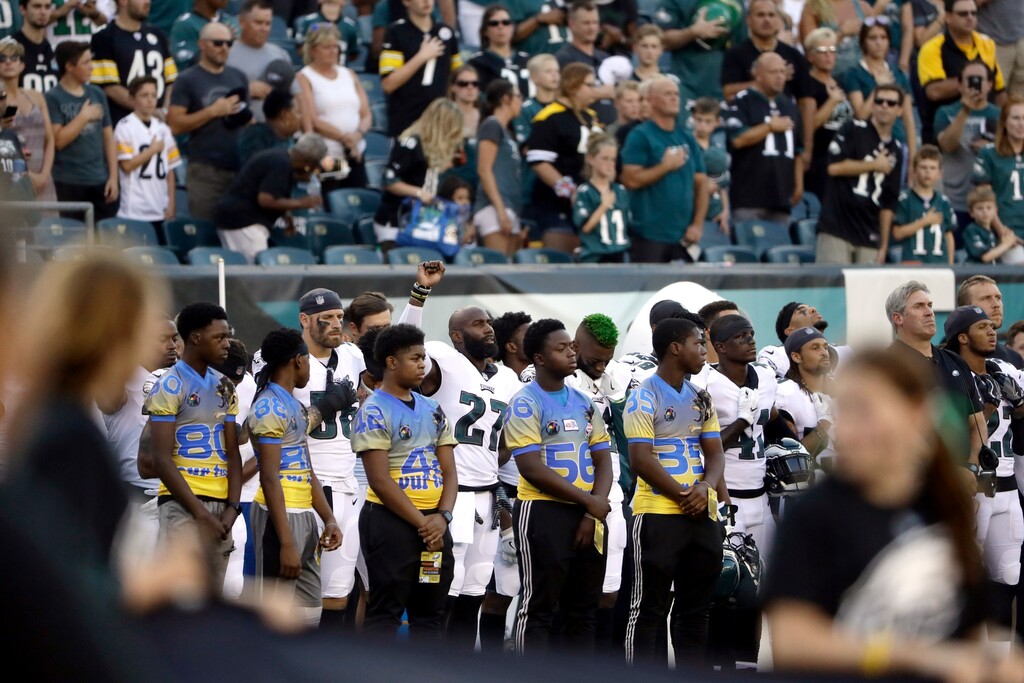 Philadelphia Eagles' Malcolm Jenkins, center left, raises his fist during the national anthem before the team's preseason NFL football game against the Pittsburgh Steelers, Thursday, Aug. 9, 2018, in Philadelphia. (AP Photo/Matt Rourke)