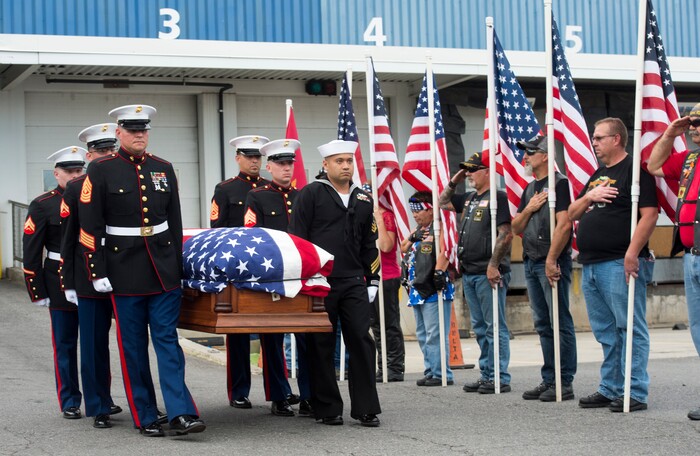 (Rick Egan  |  The Salt Lake Tribune)      The remains of Marine Pfc. Robert K. Holmes are carried from the Delta Air Cargo to a hearse for transportation to the mortuary.  Holmes died aboard the USS Oklahoma during the attack on Pearl Harbor. Friday, Aug. 17, 2018.