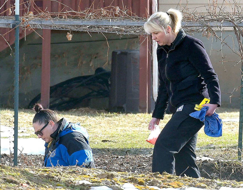 Investigators search for evidence where a missing girl was found in an irrigation ditch in Smithfield on Friday.