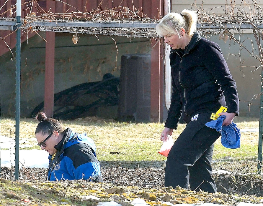 Investigators search for evidence where a missing girl was found in an irrigation ditch in Smithfield on Friday.