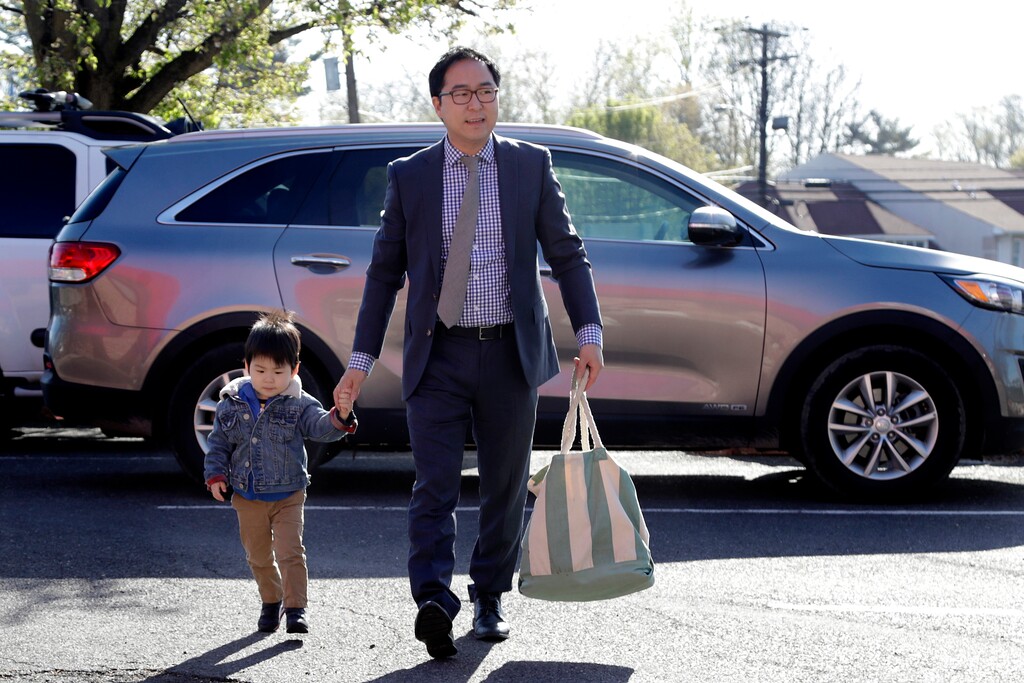 In this Tuesday, May 1, 2018, photo, Andy Kim walks his 2-year-old son, Austin Kim, to school in Bordentown, N.J. Kim, a Democrat who grew up in Marlton, N.J., is running for Congress, against Republican U.S. Rep. Tom MacArthur, a Trump supporter who helped revive the repeal of the Affordable Care Act. (AP Photo/Julio Cortez)