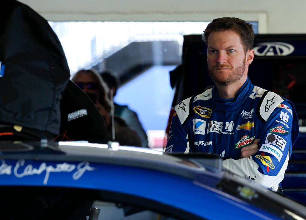 Dale Earnhardt Jr. waits by his car before the start of a practice session for the Daytona 500 NASCAR Sprint Cup Series auto race at Daytona International Speedway, Saturday, Feb. 14, 2015, in Daytona Beach, Fla. (AP Photo/Terry Renna) 