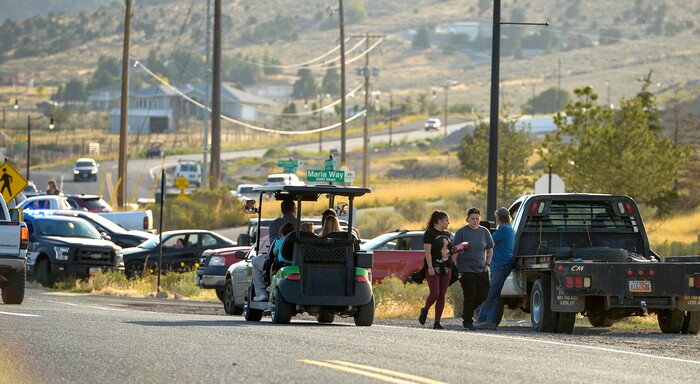 Leah Hogsten  |  The Salt Lake Tribune   Homeowners who were not allowed to return to their homes and onlookers waited near Herriman Cove pond to watch as a firefighting helicopter refilled. A 50-acre wildfire in Rose Canyon was threatened about a half-dozen homes Wednesday, Sept. 12, 2018. A spokesman for Unified Fire said the blaze has already burned a few structures, including outhouses and sheds. Firefighters have evacuated around 20 to 30 homes in two neighborhoods near 15555 S. Rose Canyon Road in Herriman. 