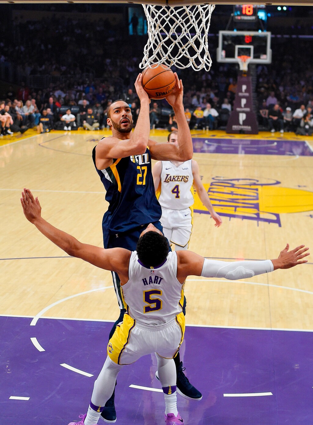 Utah Jazz center Rudy Gobert, top, of France, shoots as Los Angeles Lakers guard Josh Hart defends during the first half of an NBA basketball game Sunday, April 8, 2018, in Los Angeles. (AP Photo/Mark J. Terrill)