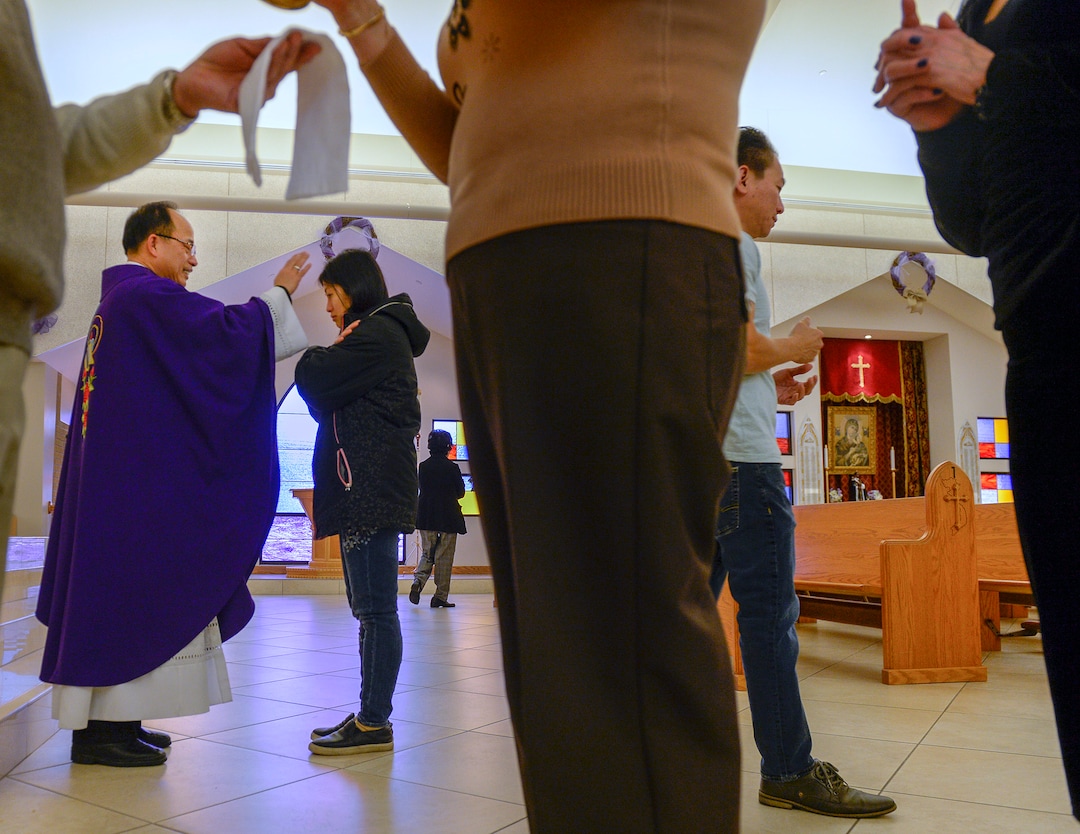 Leah Hogsten  |  The Salt Lake Tribune Rev. Tai Trong Nguyen of Our Lady of Perpetual Help Catholic church gives communion during morning mass, Wednesday, Dec. 5, 2018 in Kearns. The mostly Vietnamese congregation purchased the former Church of Jesus Christ of Latter-day Saints church in 2003. Mormons now make up less than 50% of Salt Lake County. 