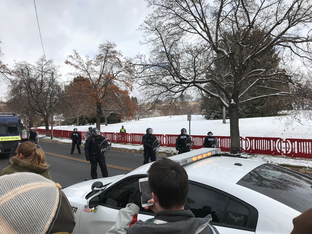 (Rachel Molenda | The Salt Lake Tribune) Police in riot gear ask protesters to move to the south side of the street near the Utah Capitol after President Donald Trump's speech inside.