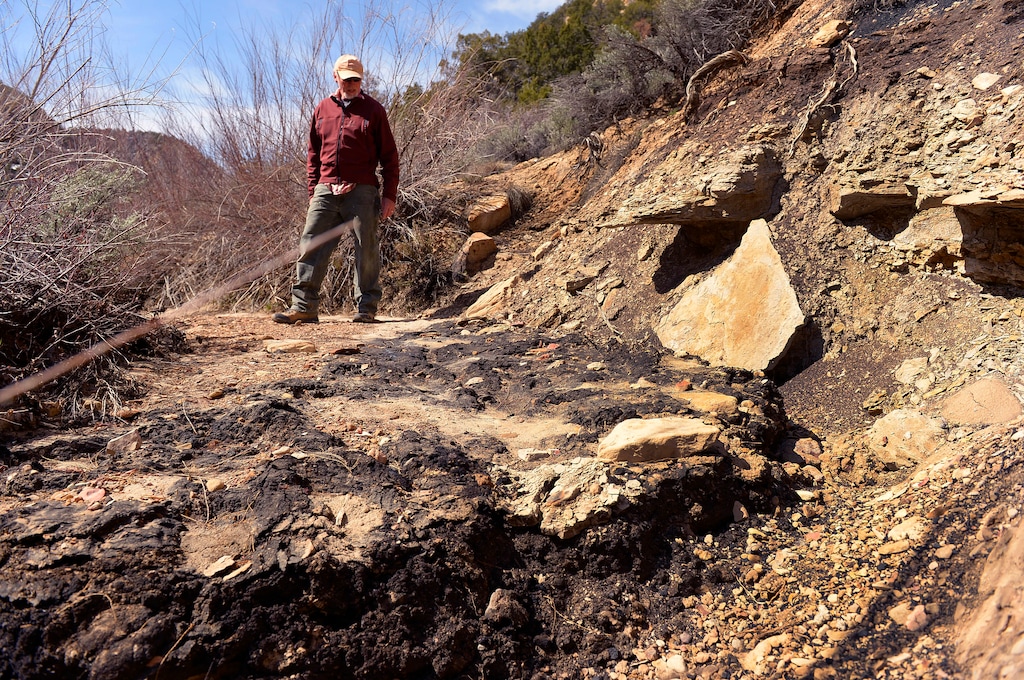 (Leah Hogsten | Tribune File Photo) Steve Defa of Escalante hikes the Little Valley Wash, Saturday, March 29, 2014 to inspect an oil spill that tainted the wash that was recently removed from the Grand Staircase-Escalante National Monument. The oil came from a ruptured pipeline in an oil field just inside the former monument boundary near Escalante. A new app enables users to document environmental damage in the West's public lands.
