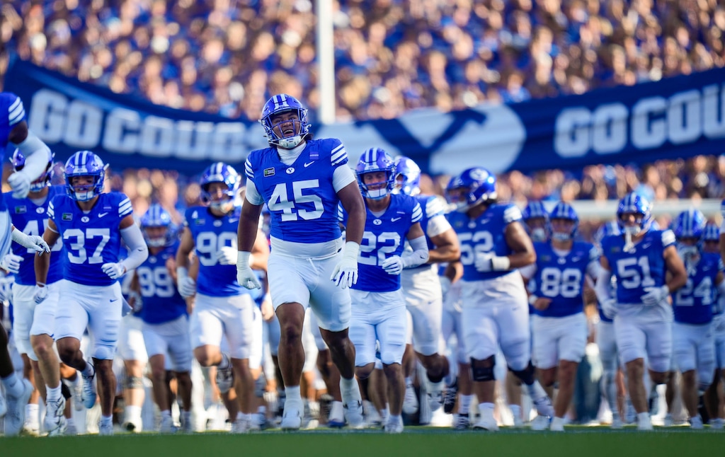 (Francisco Kjolseth | The Salt Lake Tribune) BYU players run onto the field for their NCAA college football game against Utah Tech, Saturday, Sept. 5, 2026, at LaVell Edwards Stadium in Provo.
