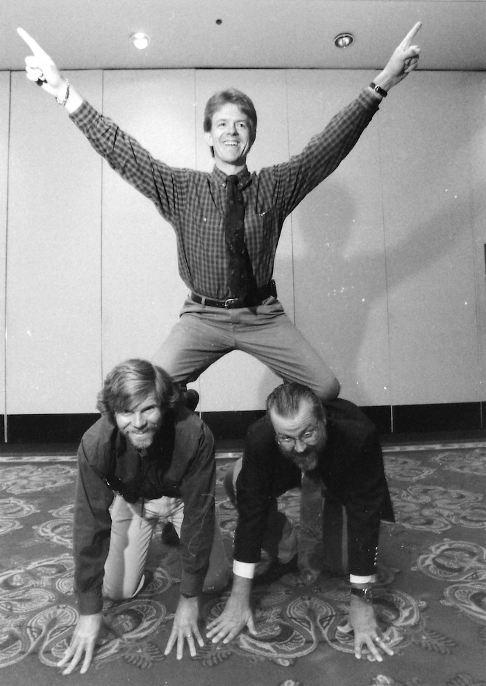 (Rick Egan | The Salt Lake Tribune) Steve Benson, top, longtime editorial cartoonist for the Arizona Republic, in 1995. He's supported in this human pyramid by fellow cartoonists Pat Bagley and Cal Grondahl. Benson died July 8, 2025, at age 71, of complications from a stroke in March 2024.