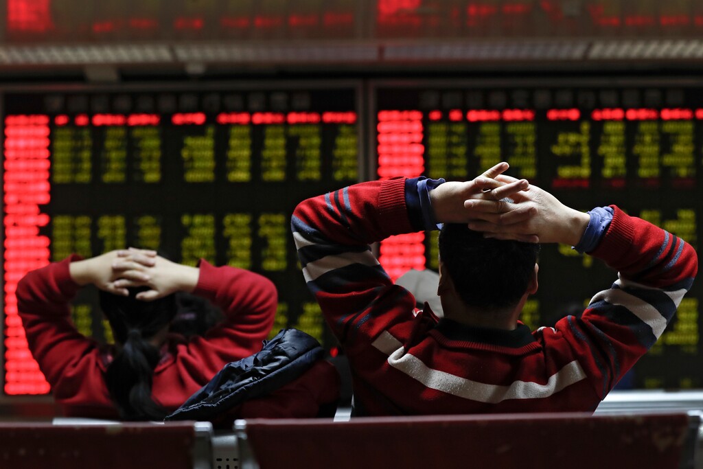 Investors monitor stock prices at a brokerage house in Beijing, Tuesday, Jan. 16, 2018. Asian stock markets have risen following a holiday for U.S. markets as investors look ahead to American corporate earnings reports. (AP Photo/Andy Wong)