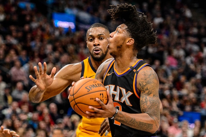 (Trent Nelson | The Salt Lake Tribune)  Phoenix Suns guard Elfrid Payton (2) drives on Utah Jazz forward Derrick Favors (15) as the Utah Jazz host the Phoenix Suns, NBA basketball in Salt Lake City, Wednesday Feb. 14, 2018.