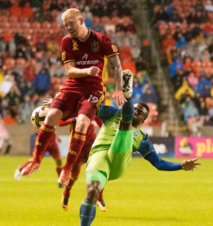(Rick Egan  |  The Salt Lake Tribune)  Real Salt Lake midfielder Luke Mulholland (19) collides with Seattle Sounders defender Nouhou Tolo (5) in MLS soccer action in Sandy, Saturday, September 23, 2017.