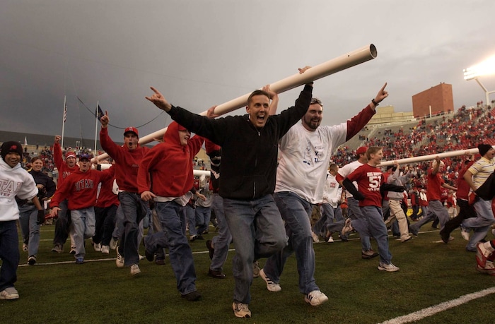 (Trent Nelson  |  Tribune file photo)  Utah fans run off with a goalpost celebrating the Utah 13-6 victory over BYU on Saturday November 23, 2002 at Rice-Eccles Stadium.