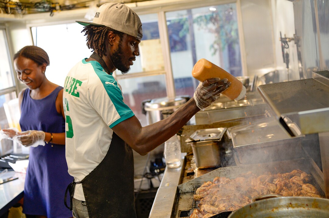 (Francisco Kjolseth  |  The Salt Lake Tribune)  Joelle Twahirwa, left, owner of the Balabe Senegalese food truck, works alongside chef Pape Sall during Trolley Square Food Truck Night as it draws people in on Wednesday, July 17, 2019. Three of the vendors that showed up, along with four others, will vie for the title of Best New Food Truck on Aug. 3 at the Food Truck and Brewery Battle at The Gateway.