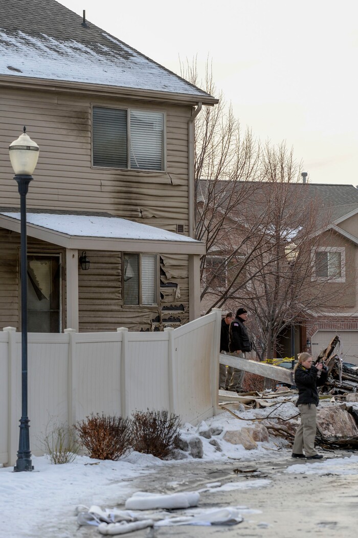(Leah Hogsten | The Salt Lake Tribune) Weber County emergency personnel and firefighters work the scene of a small, private plane that crashed in a residential neighborhood in Roy, Jan 15, 2020. A 64-year-old pilot was killed.