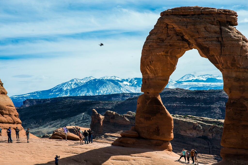 (Chris Detrick  |  Tribune file photo) Visitors take pictures and hike around Delicate Arch in Arches National Park in 2016.