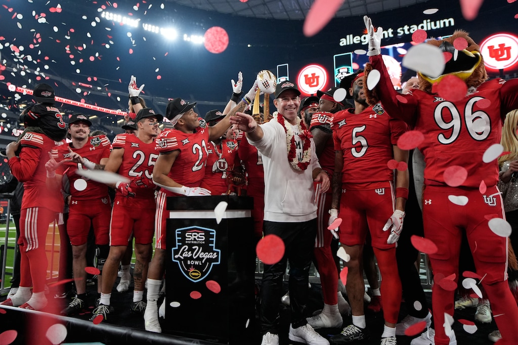 (John Locher | AP) Utah head coach Morgan Scalley celebrates with his team after defeating Nebraska in the Las Vegas Bowl, Wednesday, Dec. 31, 2025, in Las Vegas.