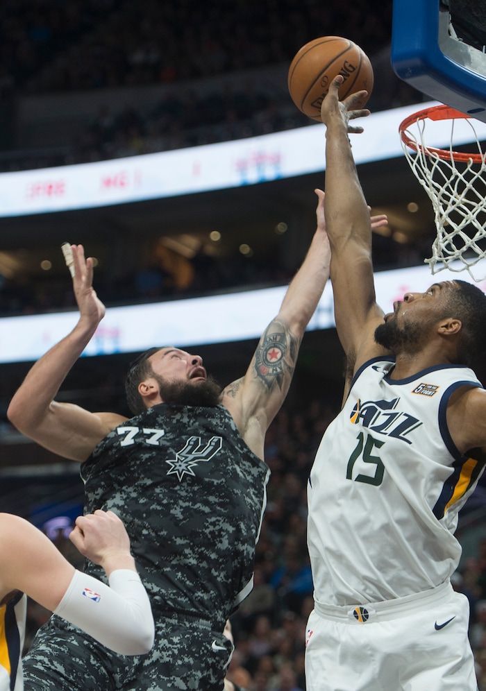 (Rick Egan  |  The Salt Lake Tribune)  San Antonio Spurs center Joffrey Lauvergne (77) shoots as Utah Jazz forward Derrick Favors (15) defends, in NBA action Utah Jazz vs San Antonio Spurs in Salt Lake City, Monday, February 12, 2018.
