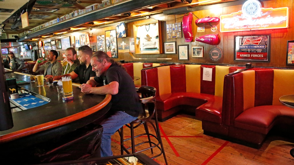 (Rick Bowmer | AP file photo) Patrons sit at the bar in Cheers to You in Salt Lake City on May 1, 2020. “We’re 100 percent back to normal,” said owner Bob Brown, “and it feels good.”