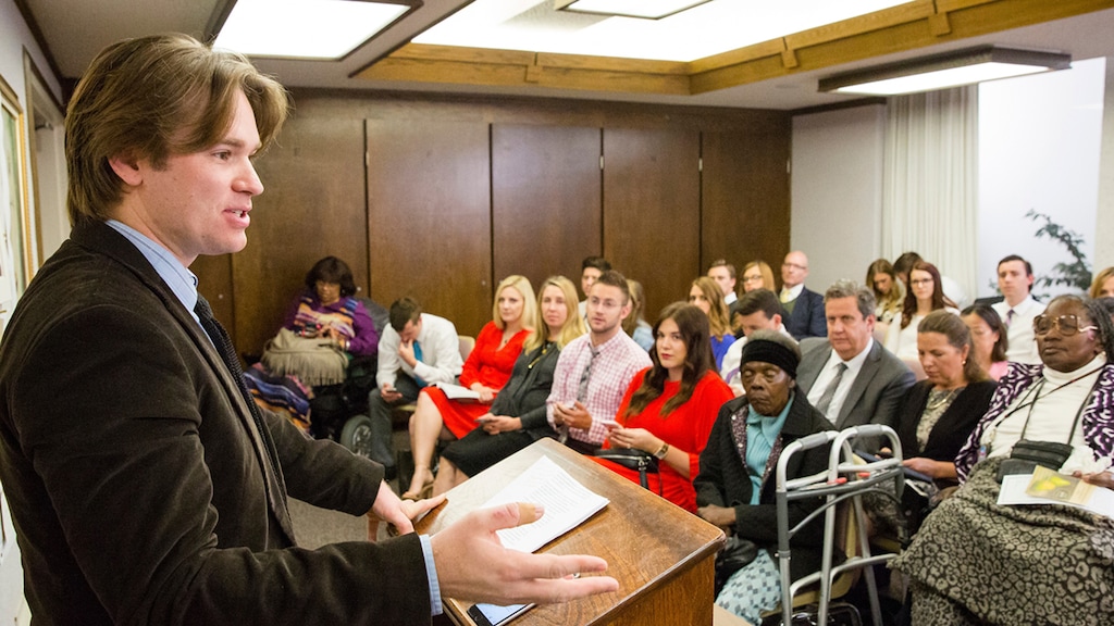 (The Church of Jesus Christ of Latter-day Saints) A teacher instructs an adult Sunday school class.