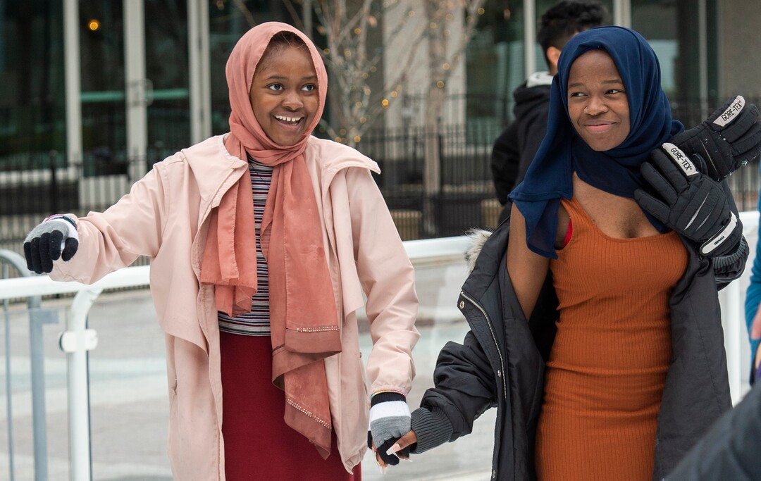 (Rick Egan  |  The Salt Lake Tribune)  Halima Hassan, 12, skates with her sister Mariam Hassan, 16, at the Gallivan Center, on Christmas Eve, Tuesday, Dec. 24, 2019.  It was the first time on ice skates for both of the girls.