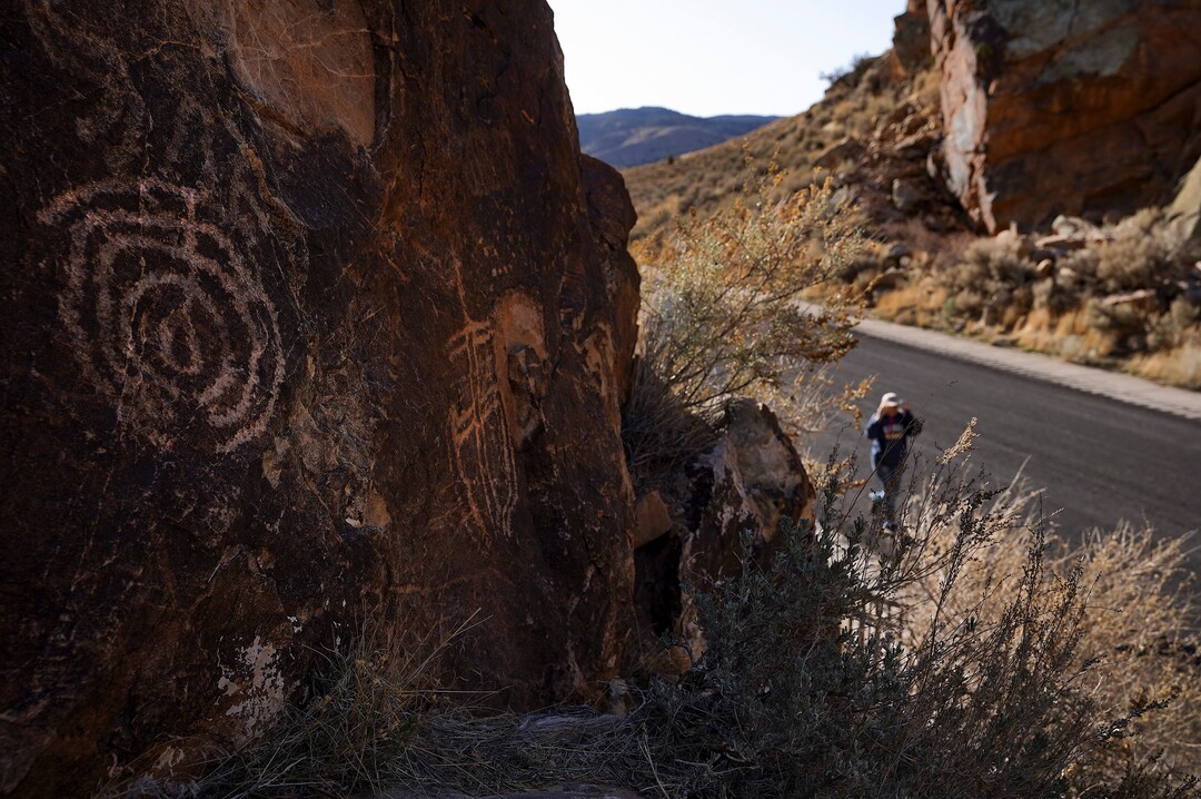(Leah Hogsten | The Salt Lake Tribune)  A visitor to the Parowan Gap, March 20, 2021. Researchers believe that the petroglyphs written into the Navajo sandstone at Parowan Gap were pecked and scratched by Native Americans who were living and farming in the Parowan Valley around 500 A.D., a time period archaeologists call the Fremont period. The Fremont Indians are closely related to the modern-day Hopi and Piute tribes and the Parowan Gap is a sacred site for both tribes.