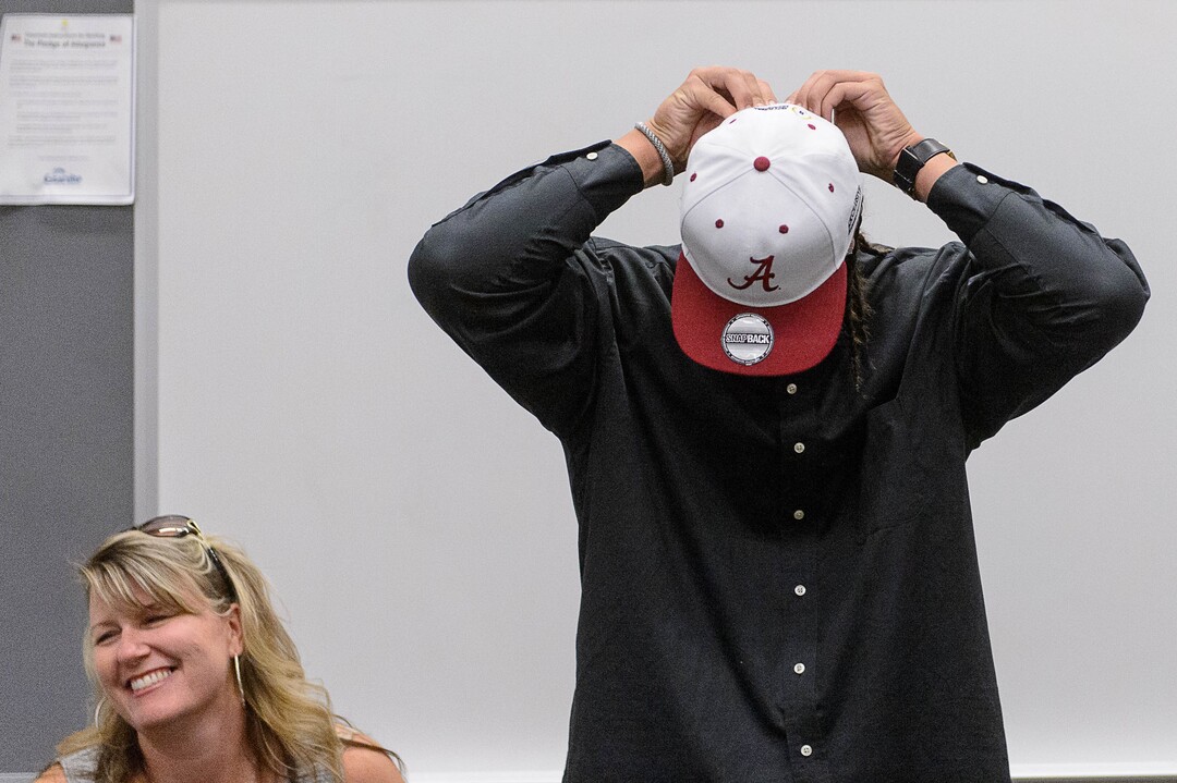 (Trent Nelson  |  The Salt Lake Tribune)  Olympus tight end Cameron Latu announces he's headed to Alabama during a news conference at Olympus High School in Salt Lake City Friday August 4, 2017. His mother Jill Argust is at left.