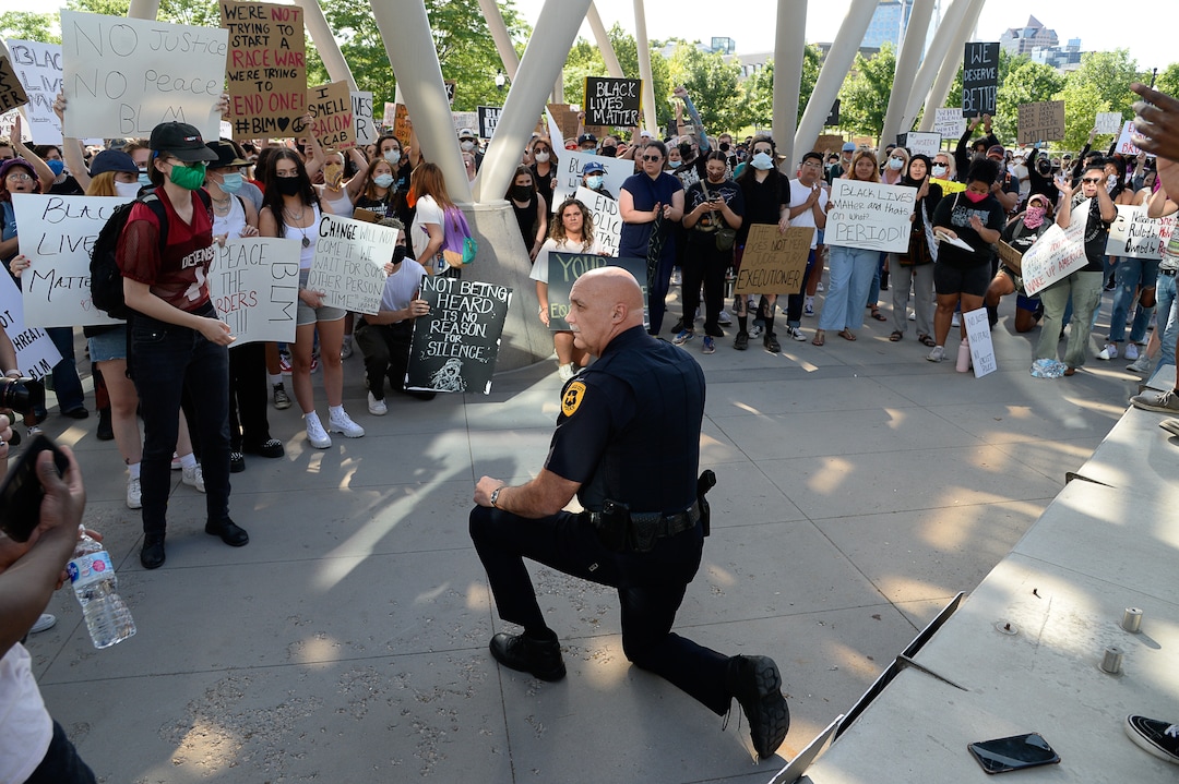 (Francisco Kjolseth  |  The Salt Lake Tribune) Salt Lake City Police Chief Mike Brown takes a knee as he shows his support of demonstrators protesting against police brutality on Wednesday, June 3, 2020, in downtown Salt Lake City, at the Salt Lake City Public Safety Building as the initially set 8 p.m. weeklong curfew was removed.