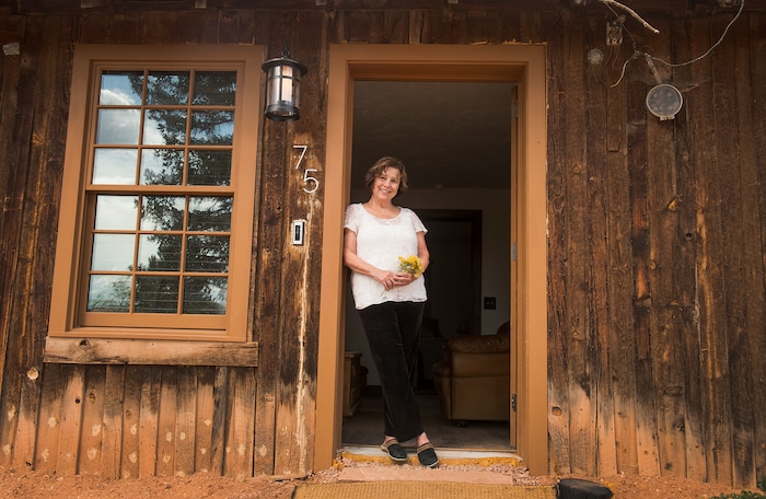 (Leah Hogsten  |  The Salt Lake Tribune) The board and batten frontier house, originally just one room, was dilapidated and boarded up and had sat vacant for 50 years, when Dawn House purchased the 1886 home in Torrey three years ago. House and her family painstakingly numbered and catalogued every board in the home to ensure its placement in its original spot. The soft pine boards still show bleached boards, where the snow drifts piled on the cabin's front since 1886.