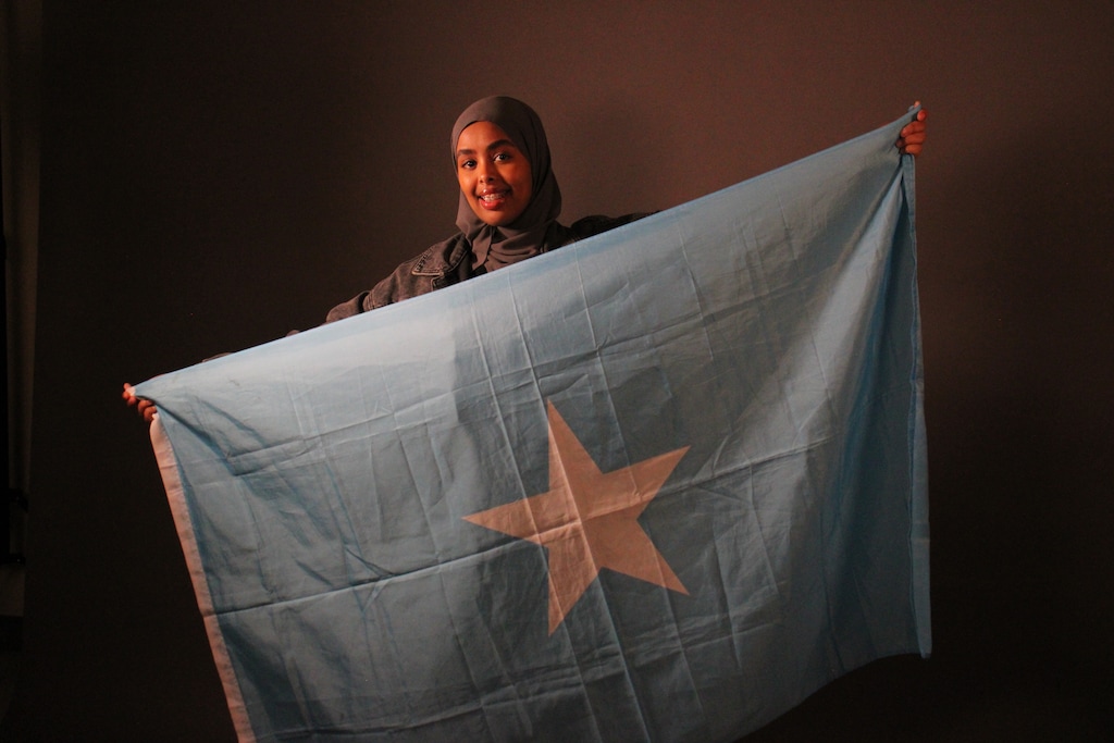 (Lauren Baese | Special to The Tribune)  Anud Hashi, a senior at Highland High School in Salt Lake City, poses with the Somalia flag. She is concerned about gun violence in her Somali community and joined a prevention organization.