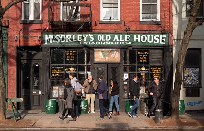 In this Dec. 27, 2019 photo, people come and go from McSorley's Old Ale House in New York. Located in Manhattan's Lower East Side, McSorley's opened in the mid-19th century, functioned as a speakeasy during Prohibition, and continues in operation today. (AP Photo/Mark Lennihan)