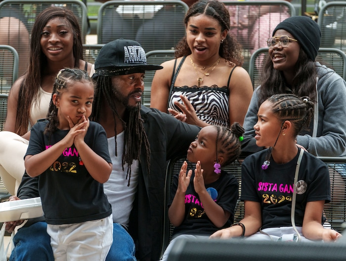(Leah Hogsten | The Salt Lake Tribune) Jalal Norrise of Ogden and his daughters l-r Jhenesiis, 6, Sura, 5 and Aeriis, 10, listen to musical performers at the Utah Juneteenth Celebration at the Ogden City Amphitheater, Saturday, June 18, 2022. 