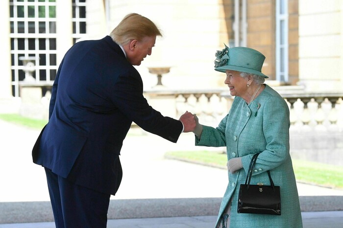 Britain's Queen Elizabeth II greets President Donald Trump as he arrives for a welcome ceremony in the garden of Buckingham Palace, in London, Monday, June 3, 2019, on the first day of a three day state visit to Britain. (Victoria Jones/Pool via AP)