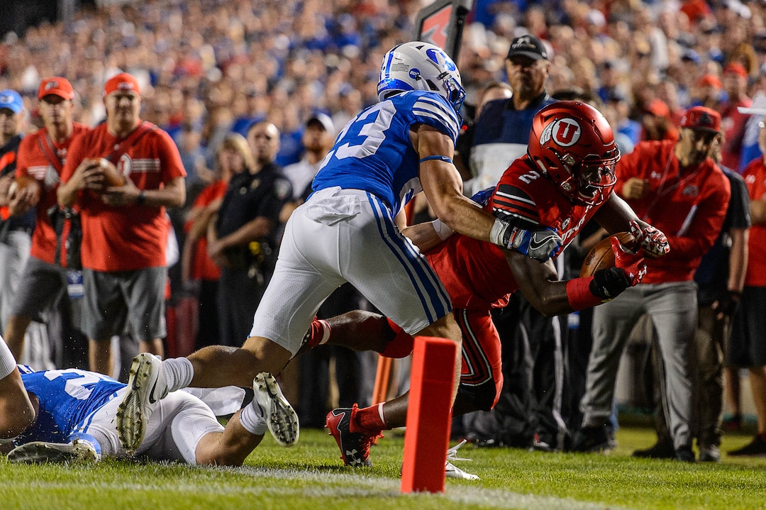 (Trent Nelson | The Salt Lake Tribune)  Utah Utes running back Zack Moss (2) is pushed out of bounds by Brigham Young Cougars defensive back Zayne Anderson (23) just short of the end zone as BYU hosts Utah, NCAA football in Provo, Saturday September 9, 2017.