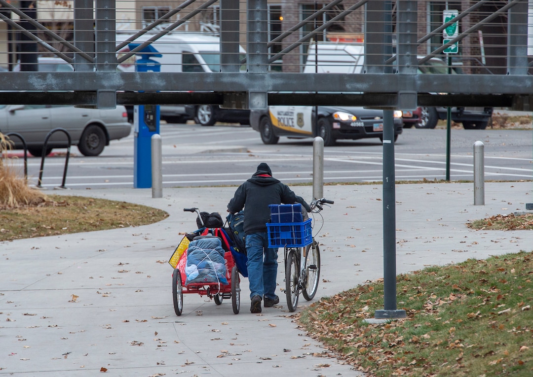 (Rick Egan | The Salt Lake Tribune)  A homeless man moves his belongings near the Salt Lake City Library, Monday, Dec. 23, 2019.