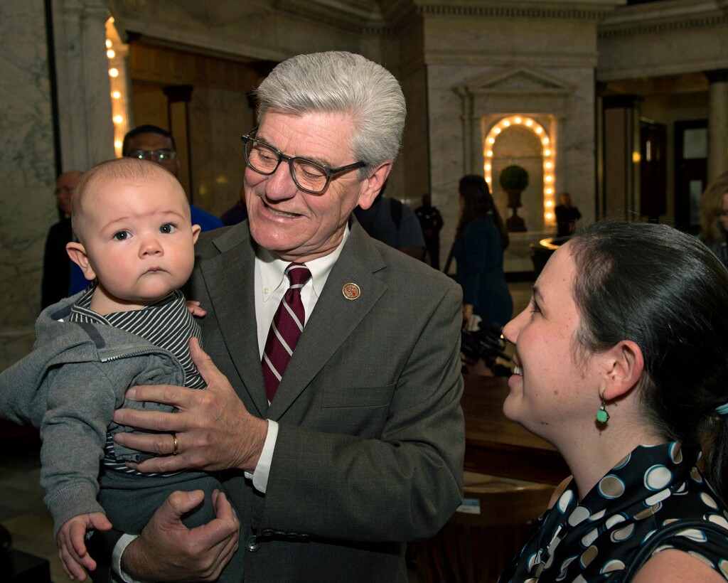 Mississippi Gov. Phil Bryant, center, holds Locke Baker, infant son of Anja Baker, right, Thursday March 21, 2019, in Jackson, Miss. Baker is the Community Relations Coordinator for the Center for Pregnancy Choices in Jackson and came to witness Bryant's signing of the heartbeat bill into law. Bryant on Thursday signed one of the strictest abortion laws in the nation — a measure that bans most abortions once a fetal heartbeat can be detected, about six weeks into pregnancy. (Sarah Warnock/The Clarion-Ledger via AP)