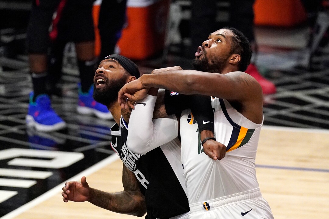 Los Angeles Clippers forward Marcus Morris Sr., left, and Utah Jazz center Derrick Favors battle for a rebound during the second half of Game 3 of a second-round NBA basketball playoff series Saturday, June 12, 2021, in Los Angeles. (AP Photo/Mark J. Terrill)