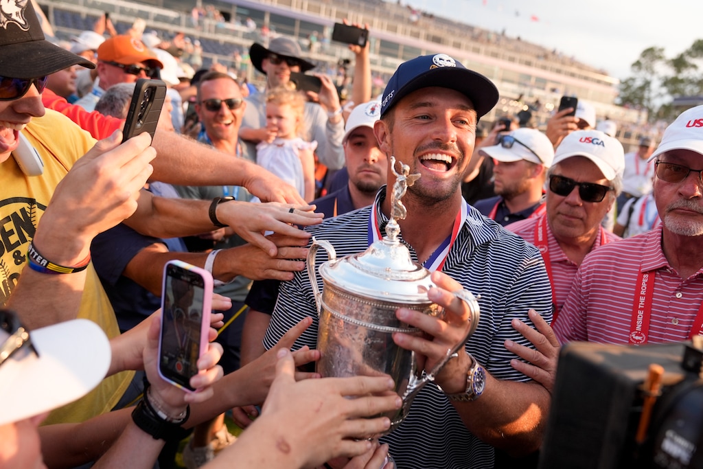 Bryson DeChambeau celebrates with fans and the trophy after winning the U.S. Open golf tournament Sunday, June 16, 2024, in Pinehurst, N.C. (AP Photo/Frank Franklin II)