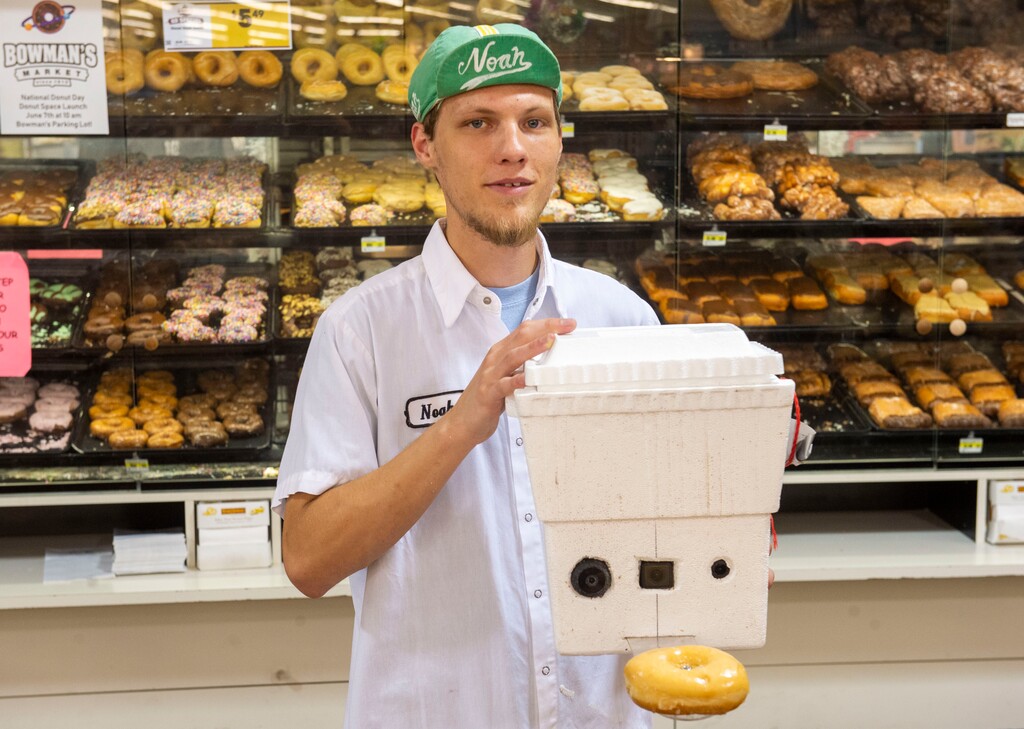 (Rick Egan  |  The Salt Lake Tribune) Noah Wenzel, the day baker at Bowman's Market in Kaysville, shows the foam cooler that will hold a glazed doughnut as it is carried into the atmosphere by a weather balloon, on Friday, June 7, as part of National Doughnut Day.