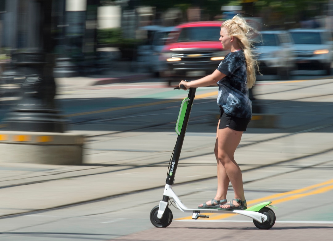 (Rick Egan  |  The Salt Lake Tribune)   A woman rides a Lime Scooter, in downtown Salt Lake City, Monday, July 30, 2018. 
