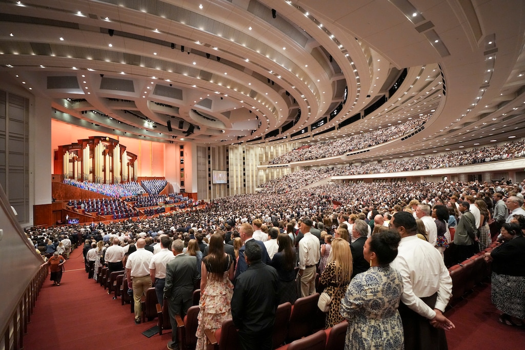 (Bethany Baker | The Salt Lake Tribune) Conferencegoers rise to sing a hymn in the Saturday afternoon session.