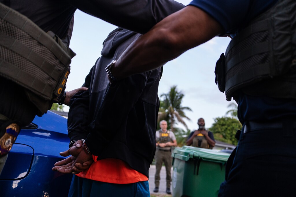 (Todd Heisler | The New York Times) An Immigration and Customs Enforcement agent makes an arrest in Miami on May 28, 2025.