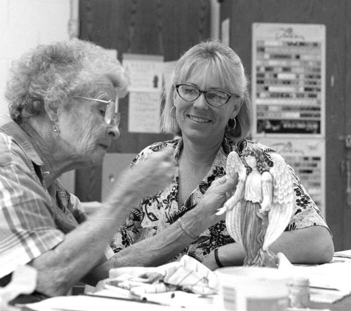 (Al Hartmann | Tribune file photo) In this undated photo, ace senior citizens reporter Patti Henetz checks out Deon McCormick's painting of a ceramic piece she made at the West Side senior center in Salt Lake City. A longtime journalist who worked at both of Salt Lake City’s daily newspapers and The Associated Press, Henetz died March 23, 2019, after suffering from a neurological disease. Henetz was 69.